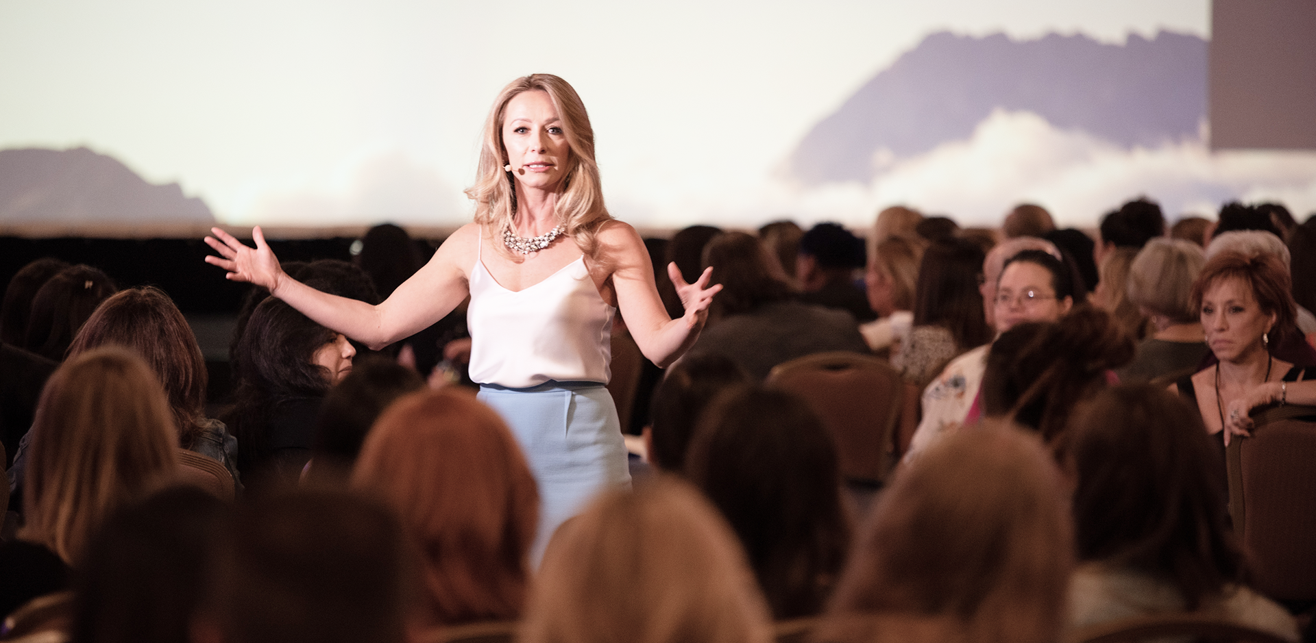 Woman speaking to an audience in a conference setting
